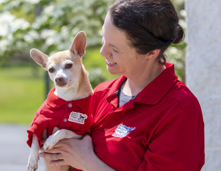 Photo of Gina Hardter holding a shelter dog.