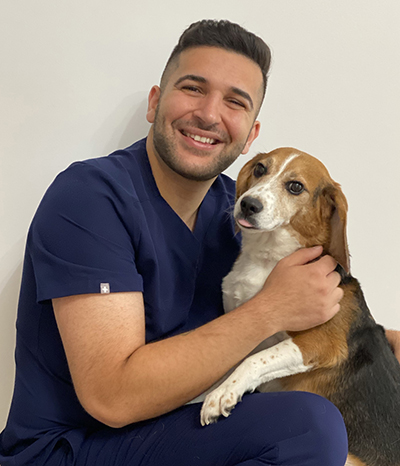 Nima Morady poses with a cute beagle named Herschel.