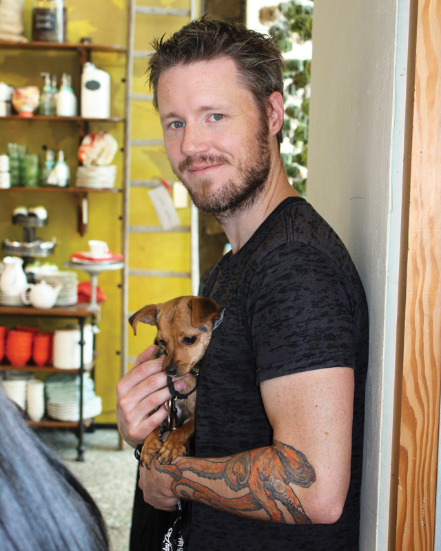 a man holds a small dog