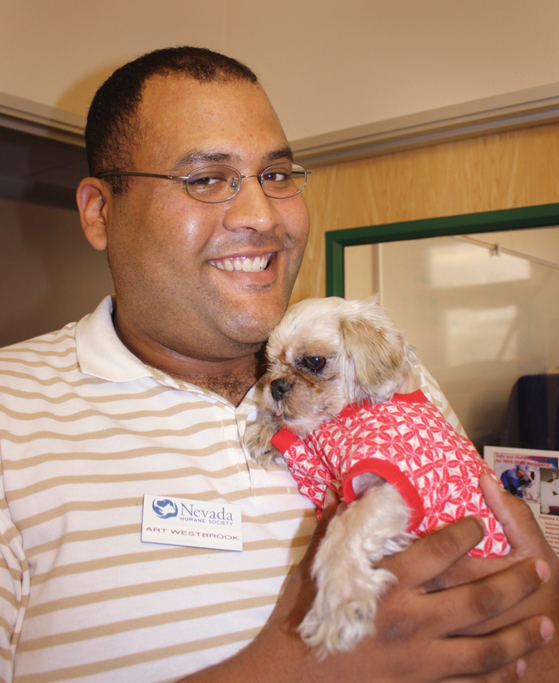 a man holding a small dog