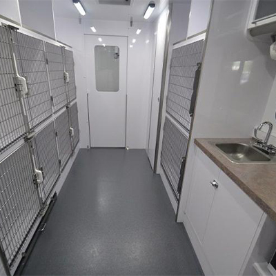 Fido Fixers interior of van showing cages and a sink area.