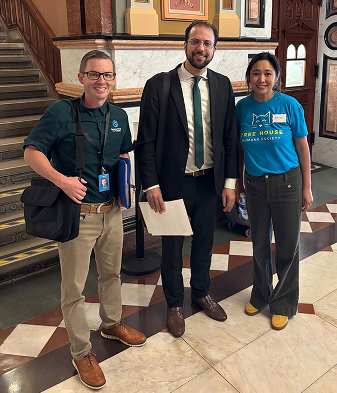 three people standing inside a government building