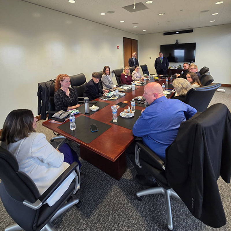 a group of people meeting in a board room