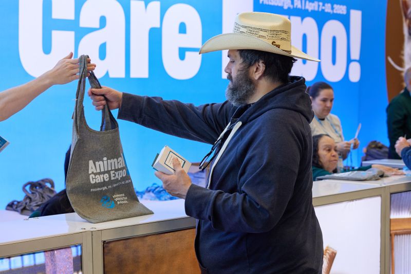 Attendee being handed an Expo bag