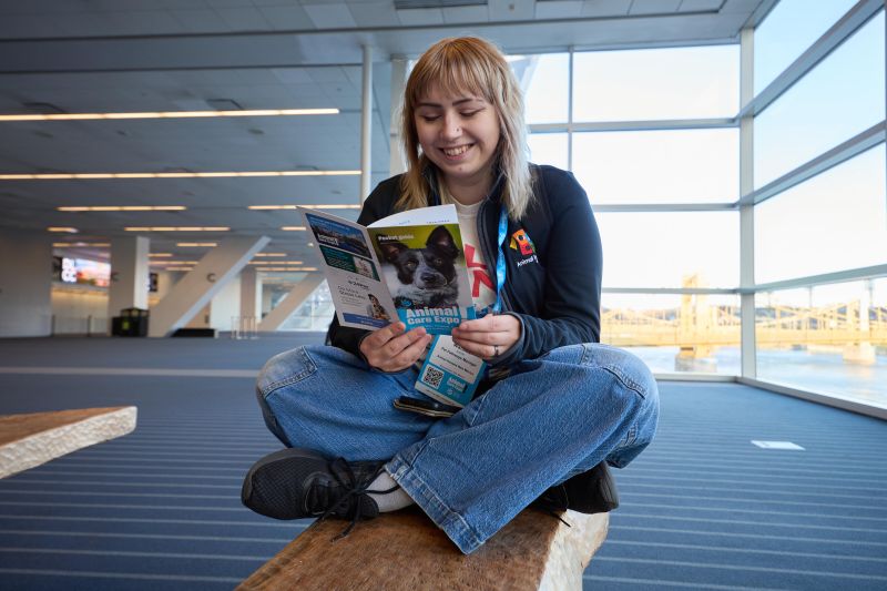 Attendee reading a pocket guide