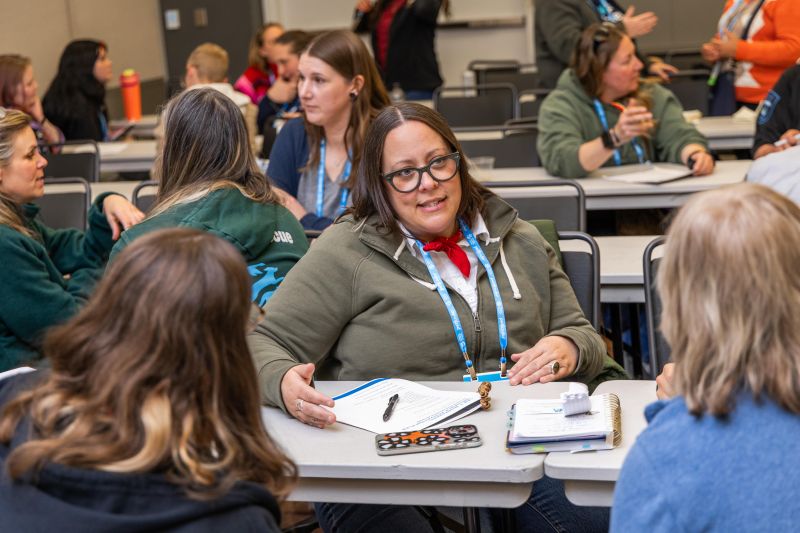 Attendee in a workshop talking to other attendees