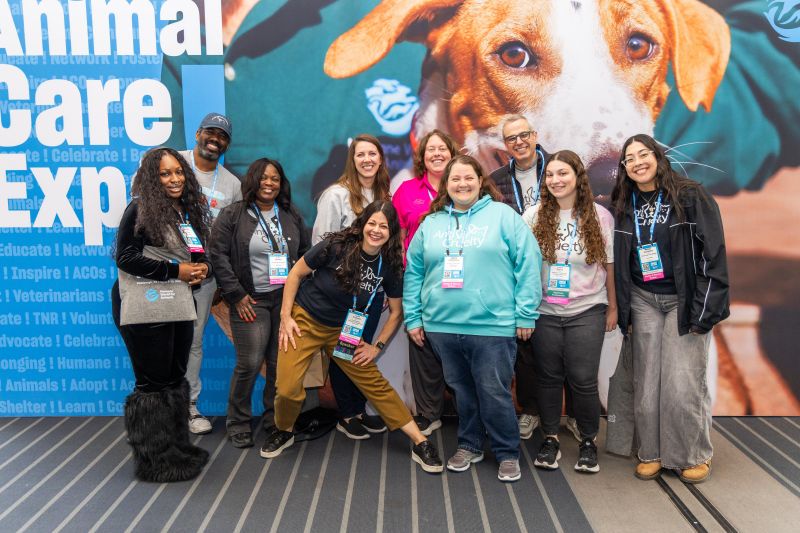 Group of attendees in front of an Expo sign