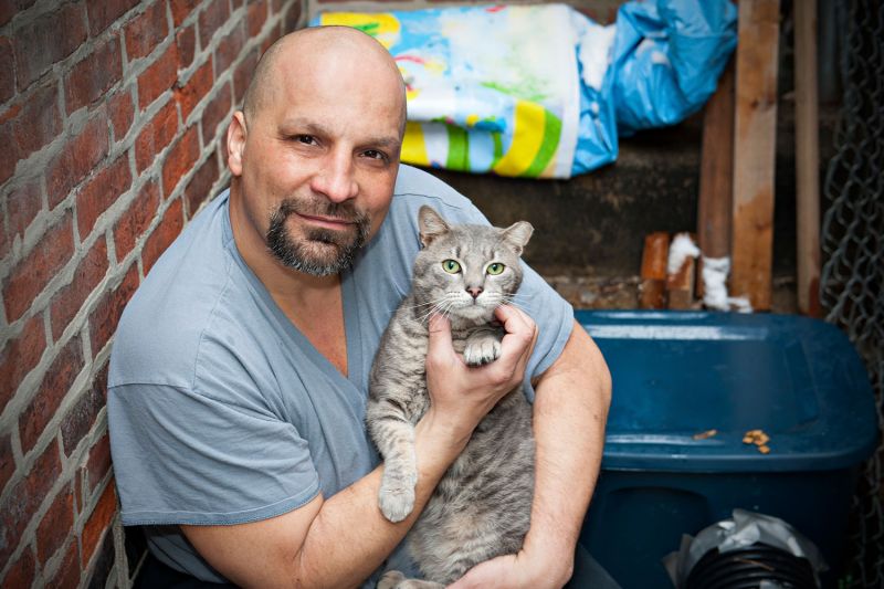 Man with grey cat