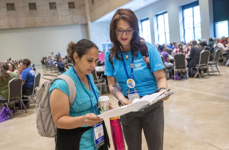 Volunteer helping an attendee