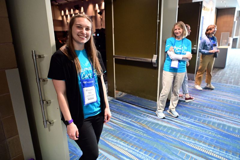 two women stand in front of open doors