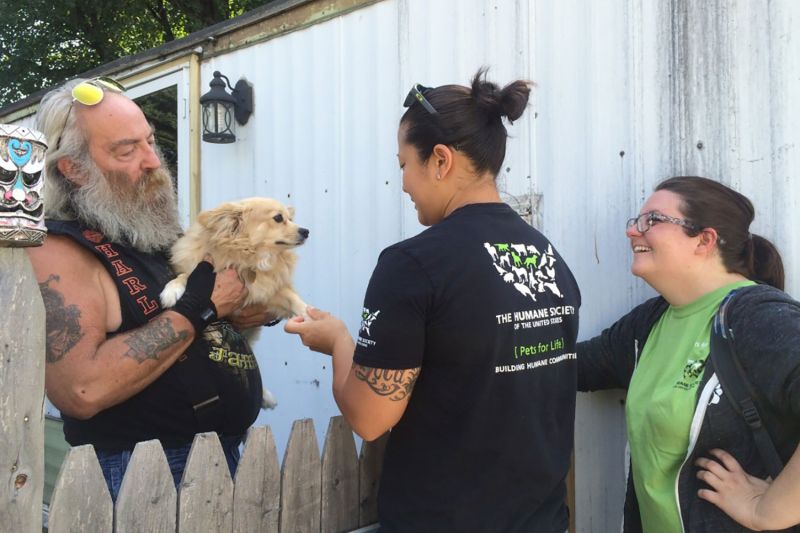 Pets for Life volunteer with dog and owner