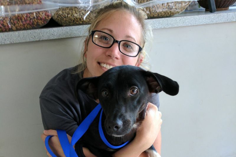 a woman hugs a dog