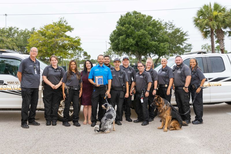 A group of animal control team members with a few dogs.