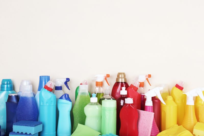 an assortment of cleaning products arranged by color