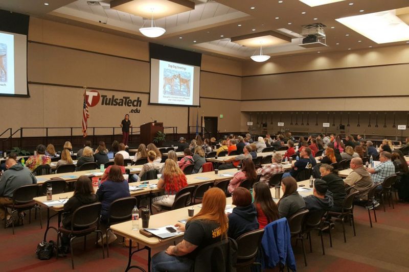 a large group of people listening to a speaker