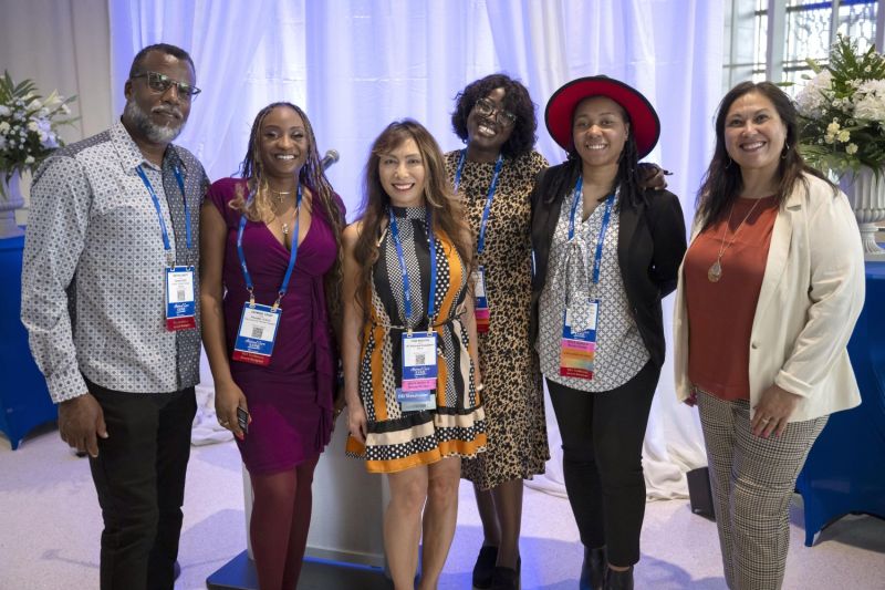 A group of attendees smiling at the camera