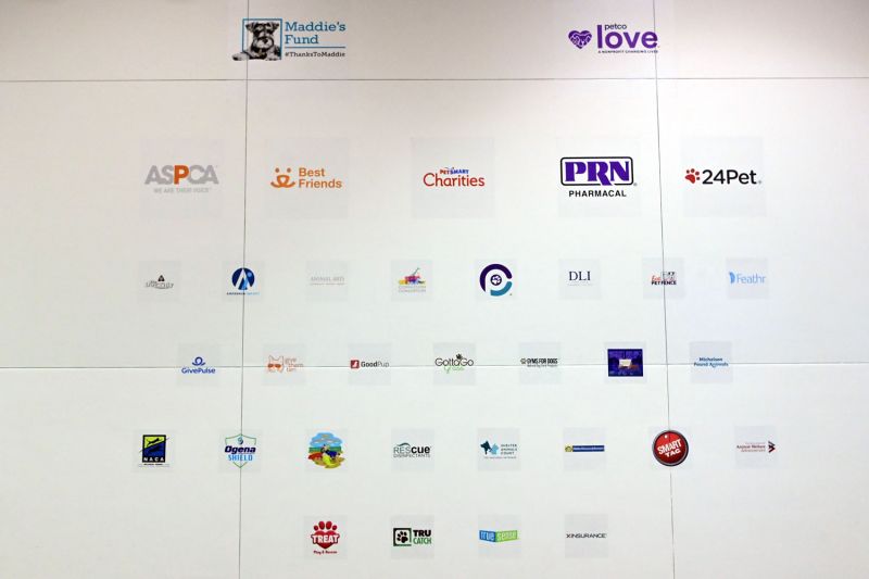 a collection of sponsor logos on a white wall