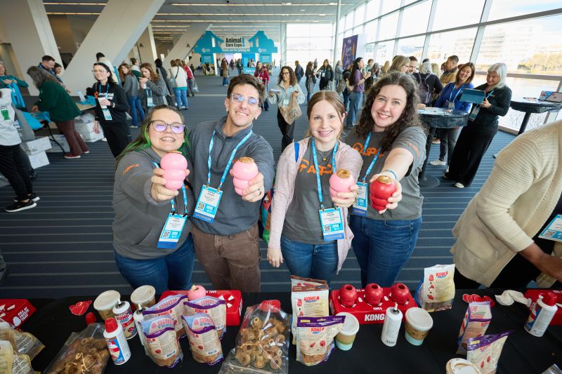 Attendees holding up KONGs