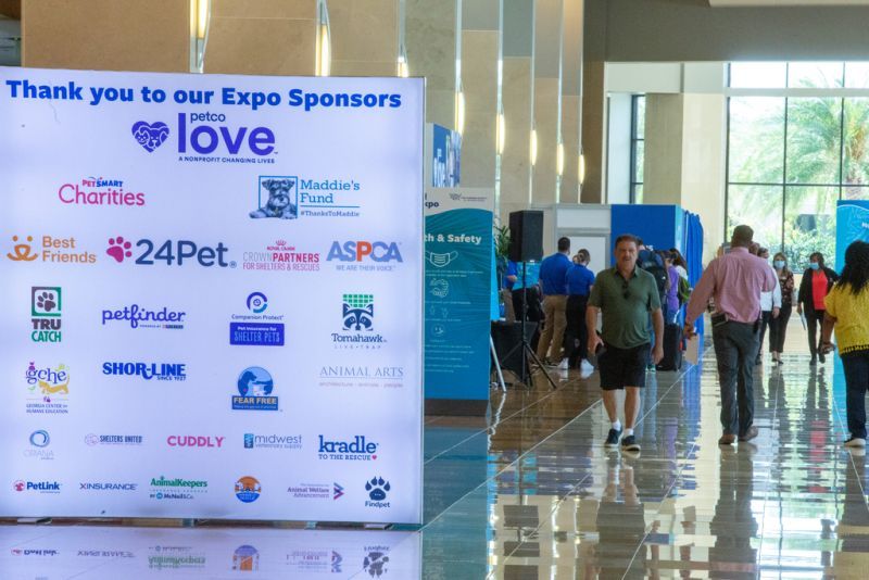 a list of expo sponsors on a large sign at the conference