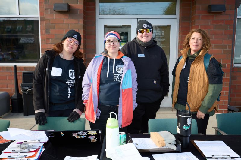 Attendees at CAWS Day behind a table