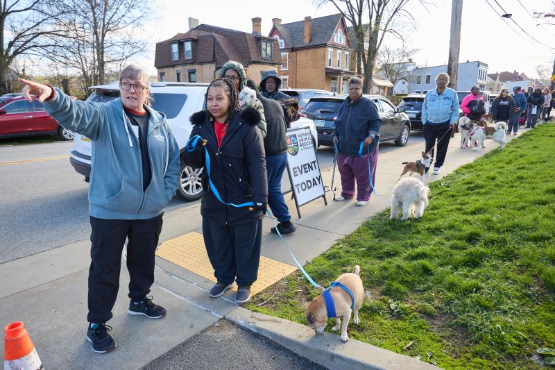 Volunteer pointing out where to go at CAWS Day