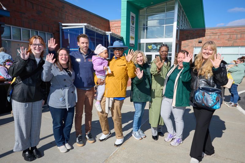 Group of legislators at CAWS Day waving their hands 