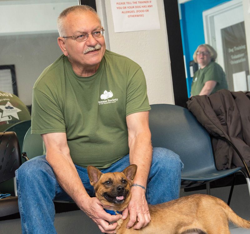 a man pets his dog