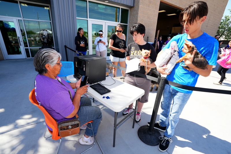 Volunteer assisting with tag machine