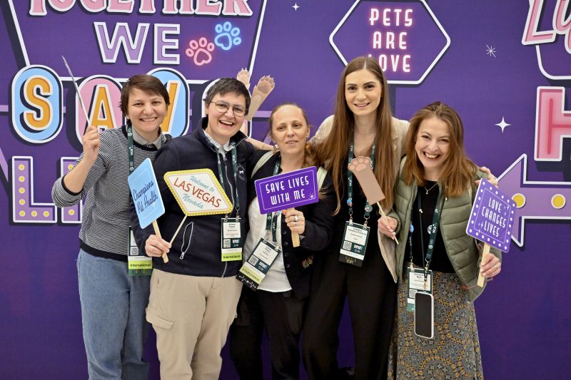 Group of people in front of a backdrop