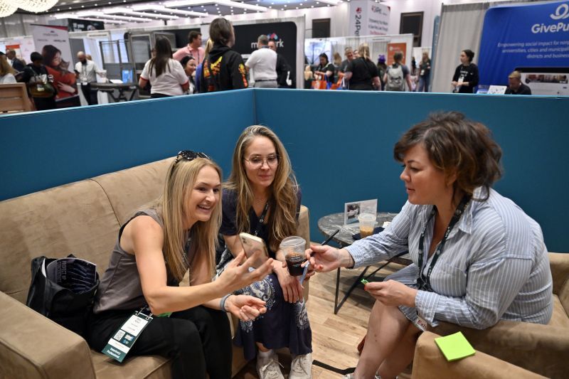 Attendees view conference information on a cellphone.