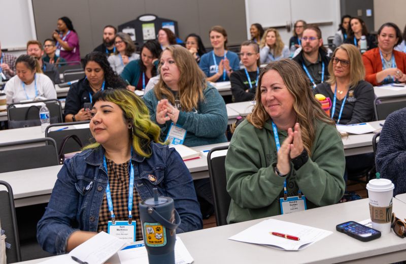 Attendees in a workshop clapping