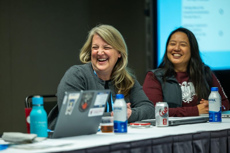 Two speakers laughing