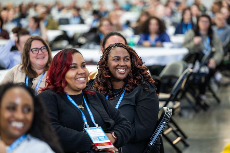 Audience members at the Expo main stage smiling