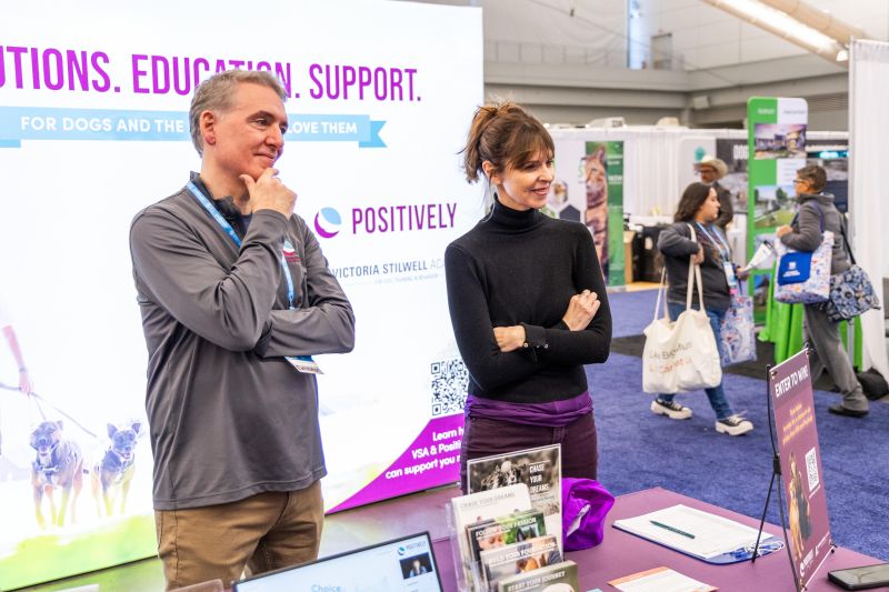 Victoria Stilwell and exhibitor at their exhibit hall table