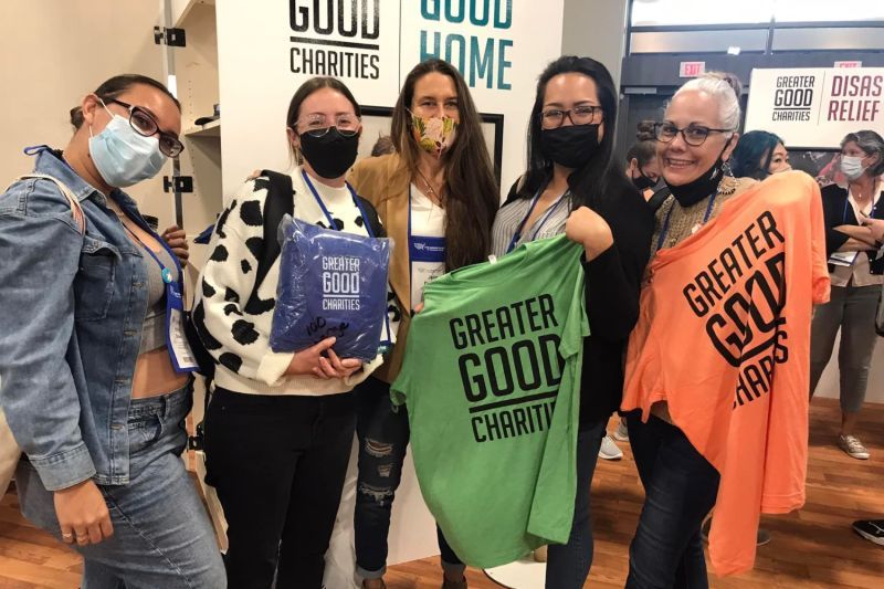 a group of people holding up greater good tshirts