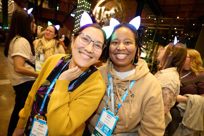 Attendees with cat ears smiling