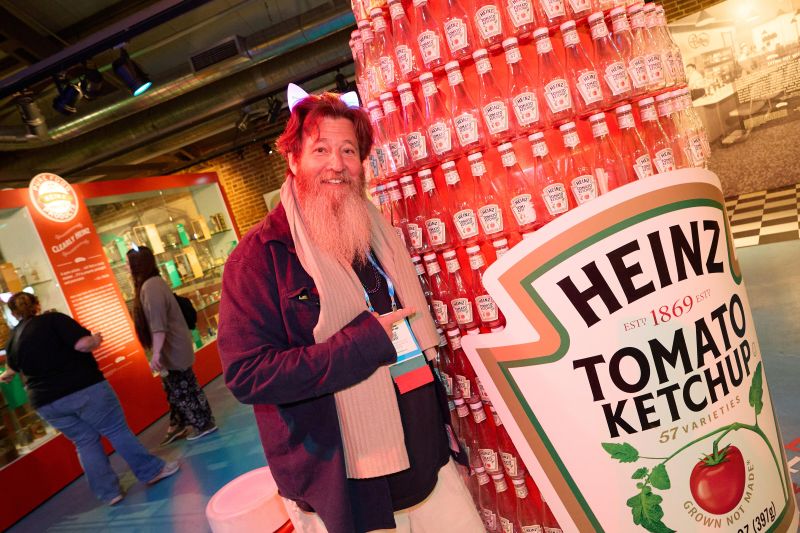 Attendee in front of Heinz ketchup display