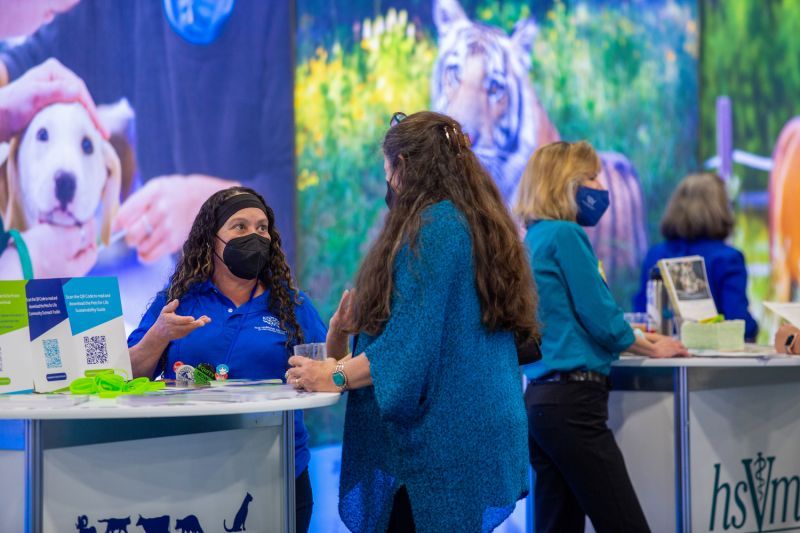 two people talking at an Expo booth
