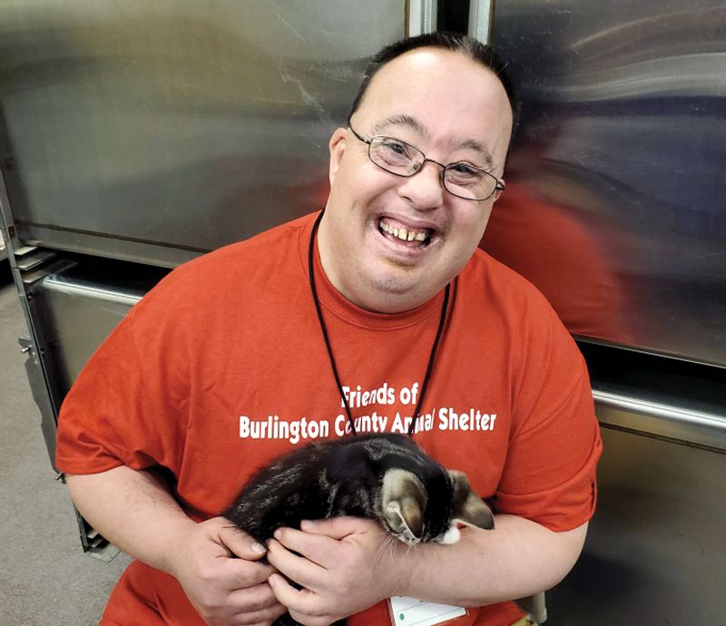 a man holds a kitten