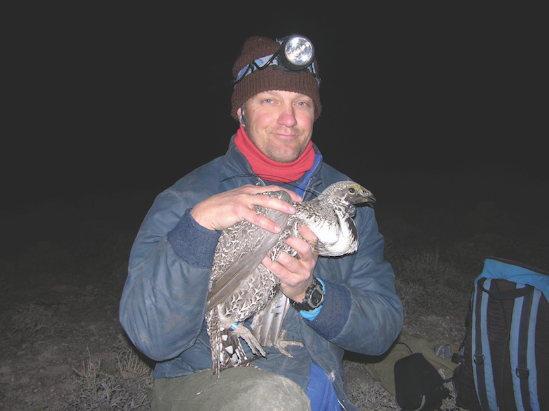 a man holding a bird