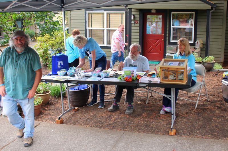 Organizers of a catio tour greet attendees and provide information.