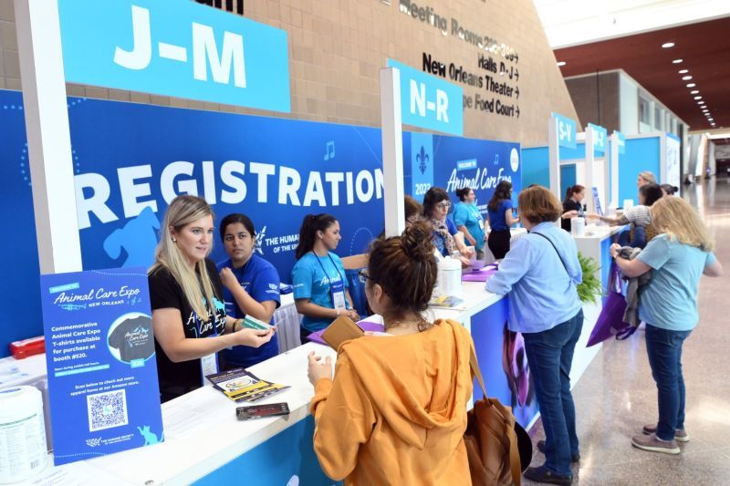 attendees check in at the registration booth