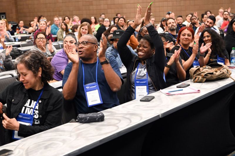 attendees clap and cheer at the end of a breakout session