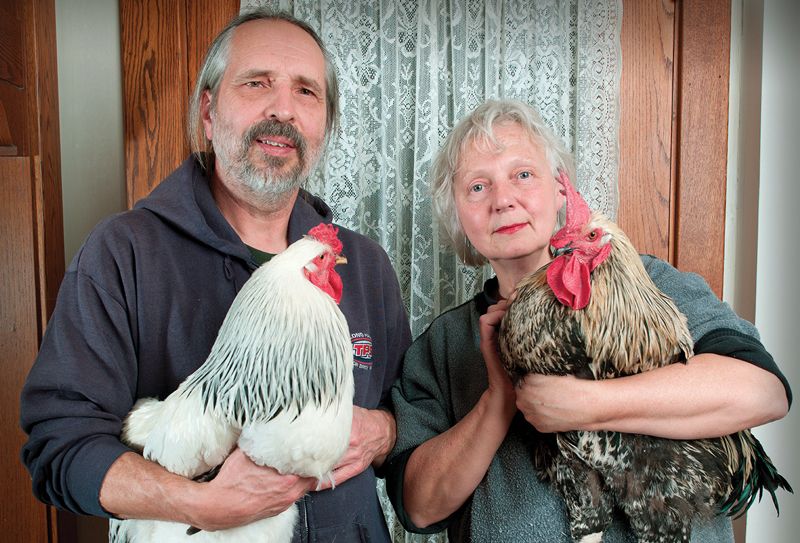 a couple posing with their birds