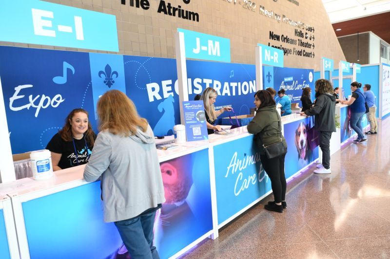 attendees being greeted at the expo registration desk