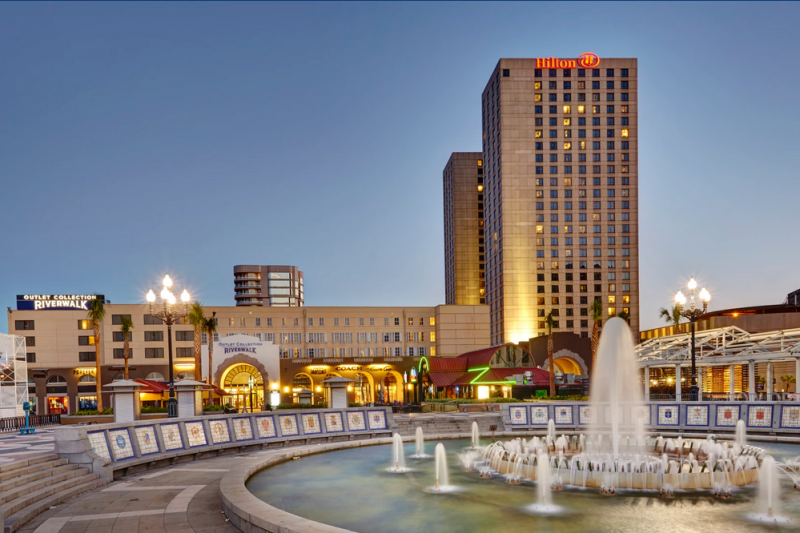 the Hilton New Orleans Riverside with a fountain in the foreground