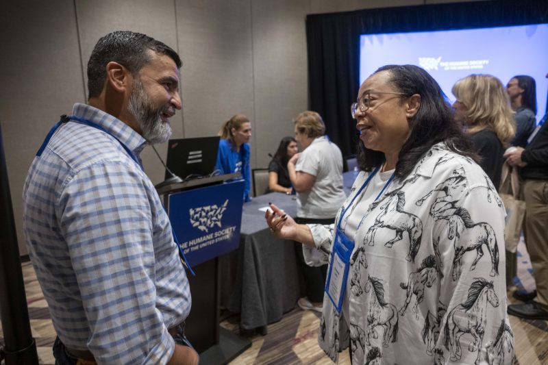 Two attendees speaking after a workshop