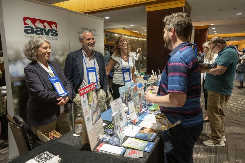 Exhibitors speaking to an attendee