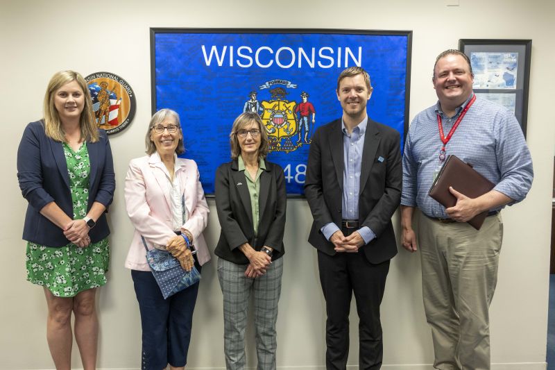 Attendees in front of Wisconsin sign