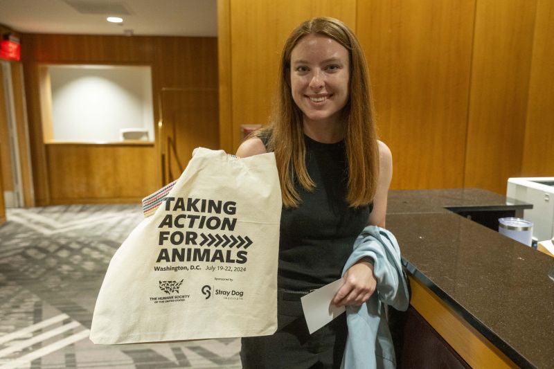 Attendee holding TAFA tote bag